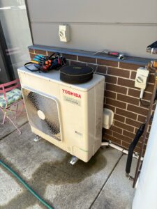 Existing Toshiba outdoor air-conditioning unit before replacement at a Narrabundah villa.