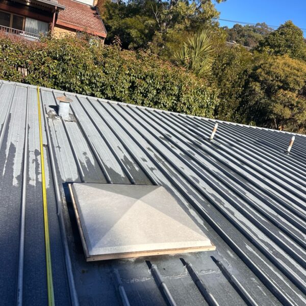 Wide view of the flat metal roof at a large single-storey home in Canberra.