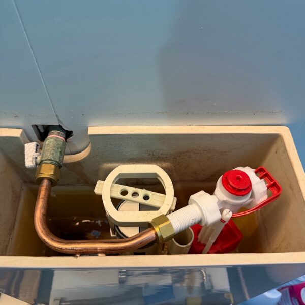 Image: Internal cistern parts inspected while repairing a constantly running toilet at an Inner City apartment Internal toilet cistern parts and plumbing tools visible during a repair at an Edinburgh Avenue apartment.