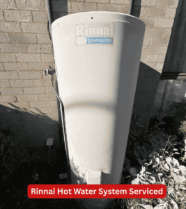 Rinnai Sunmaster solar hot water storage tank beside a large single-storey home in Chapman.