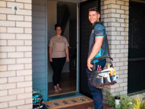 JML Trades plumber arriving at the front door of a home.